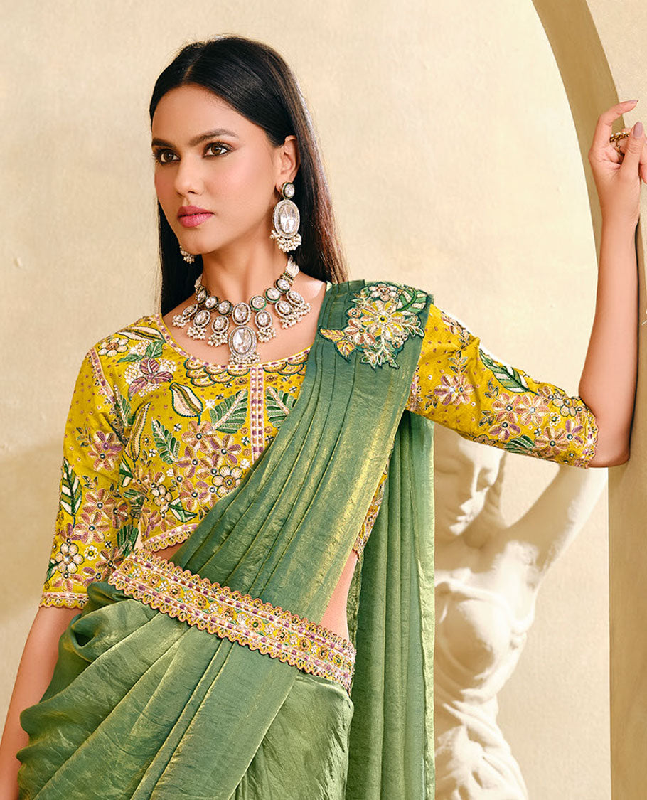 Cardamom Green Plain Party Wear Designer Saree, Complemented with a Contrast Round Neck Heavy Embroidered 3/4th Sleeve Readymade Blouse, Detachable Embroidered Belt, and a Free Embroidered Flap Sling Bag