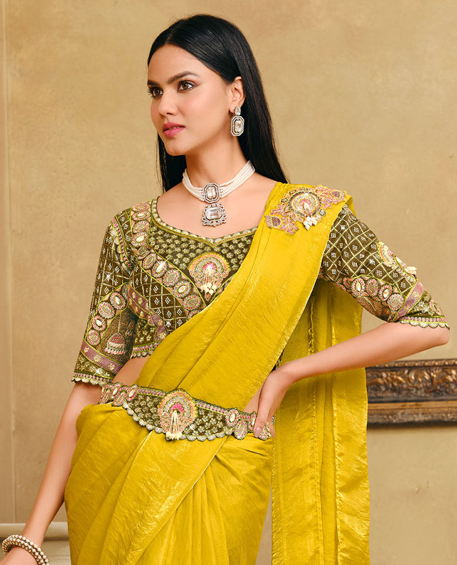Yellow Plain Party Wear Designer Saree, Complemented with a Contrast Sweetheart Neck Heavy Embroidered Elbow Sleeve Readymade Blouse, Detachable Embroidered Belt, and a Free Embroidered Flap Sling Bag
