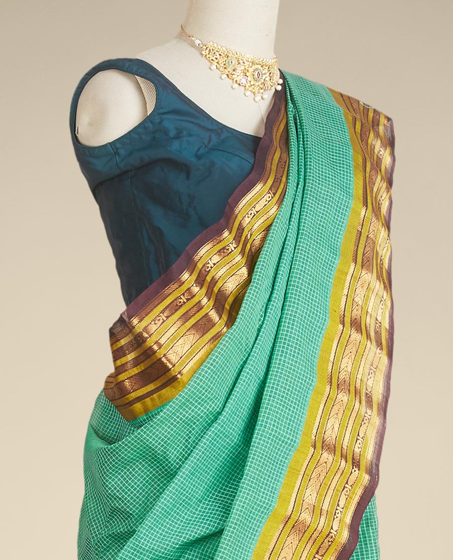 Green micro-checked gadwal saree, contrast border & pallu steeped with traditional zari designs