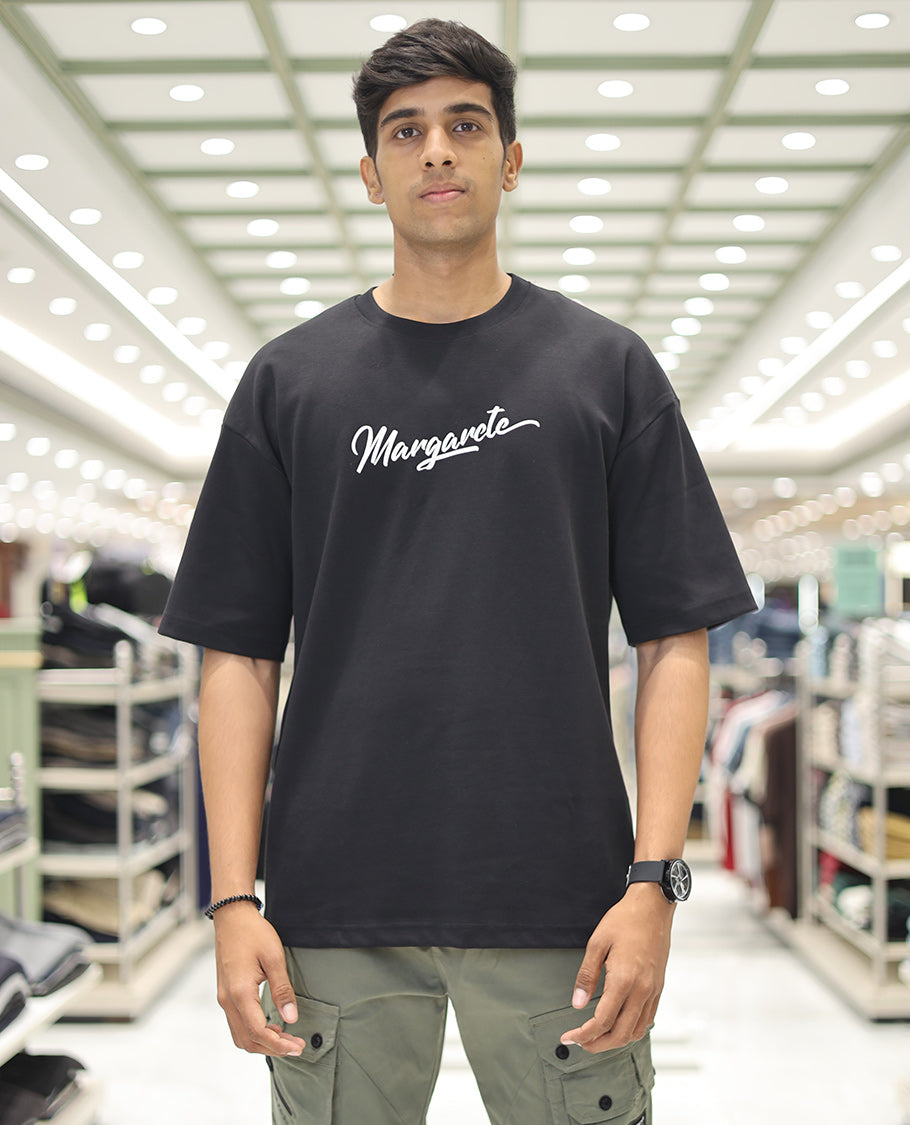 Black Glow in the Dark Cotton-Blended T-Shirt, Accentuated with Colorful Cartoon Motifs Print, Comes with a Crew Neck, Half-Sleeves, Oversized Fit, and Long Length