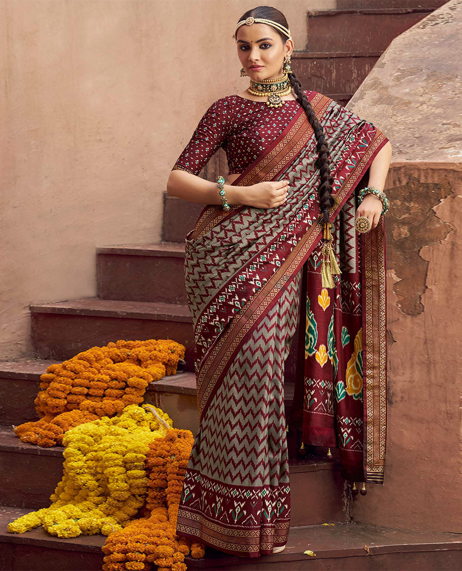 Grey-Maroon Ikat Patola Designer Saree, Adorned with Ikat Chevron Stripes, Complemented by a Contrast Ikat Border, Ikat Woven Pallu, and a Contrast Blouse