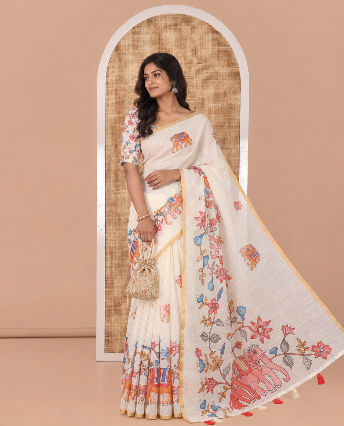 Cream Linen Cotton Saree, Bedecked with Elephant Motifs Printed on Its Body, Subtle Piping Border, Pallu of Floral and Elephant Designs, and Paired with a Matching Blouse