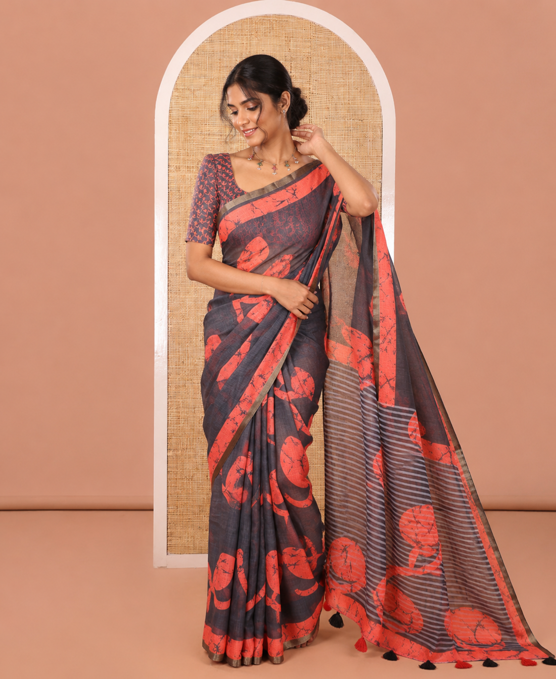 Black Linen Cotton Saree Highlighted with Batik-Style Fancy Vines Printed All Over Its Body, Simply Made with a Contrast Batik Printed Zari Border, Pallu of Stripes and Batik Print, and Paired with a Matching Blouse