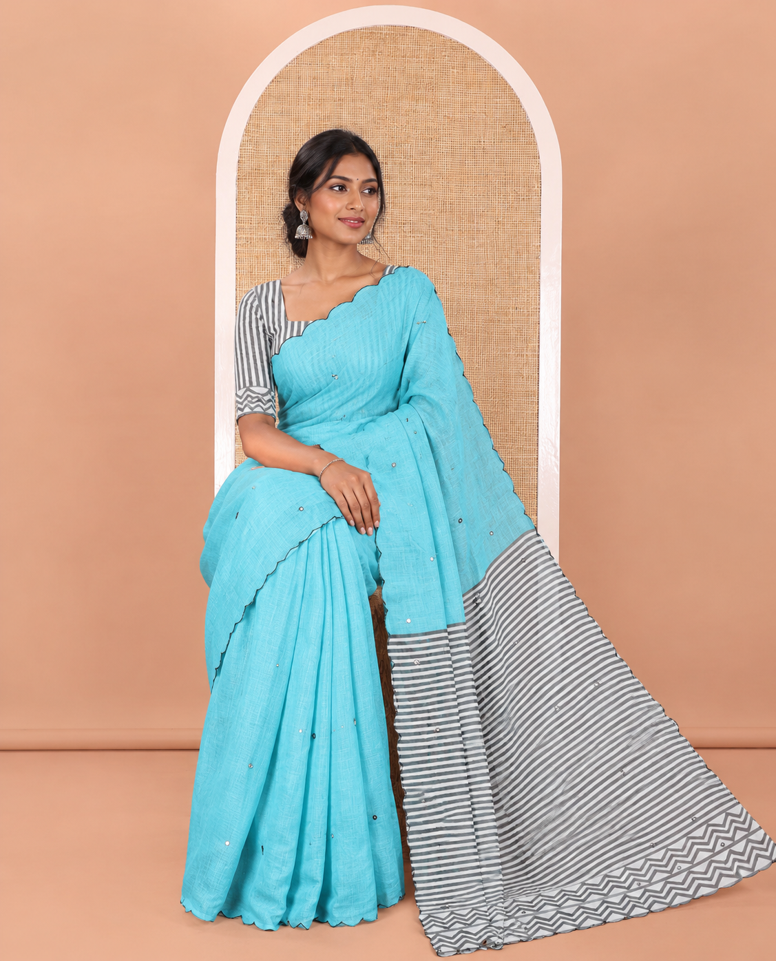 Blue Linen Cotton Saree, Embellished with Mirror Work All Over Its Body, Subtly Scallop Border, Complemented by Contrast Pallu of Stripes and Mirror Work, and Paired with a Contrast Geometric Printed Blouse