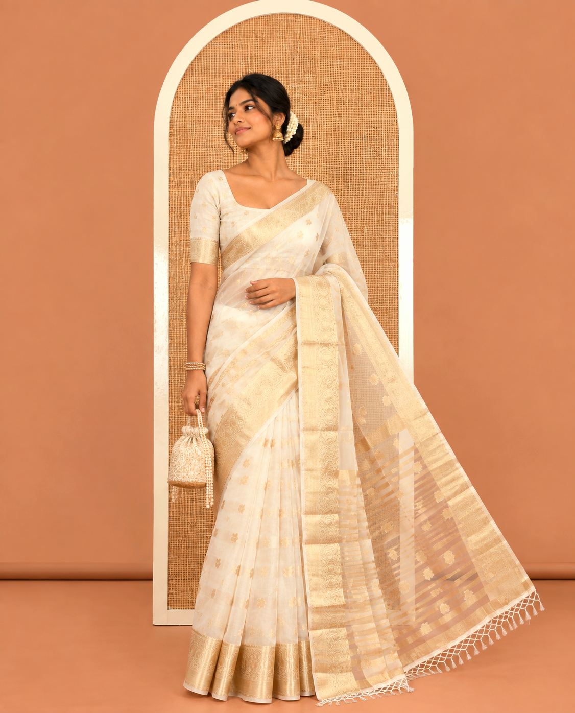Cream Semi-Organza Saree, Masterfully Woven with Zari Buttas, Highlighted by a Zari Paisley Border, and a Matching Blouse