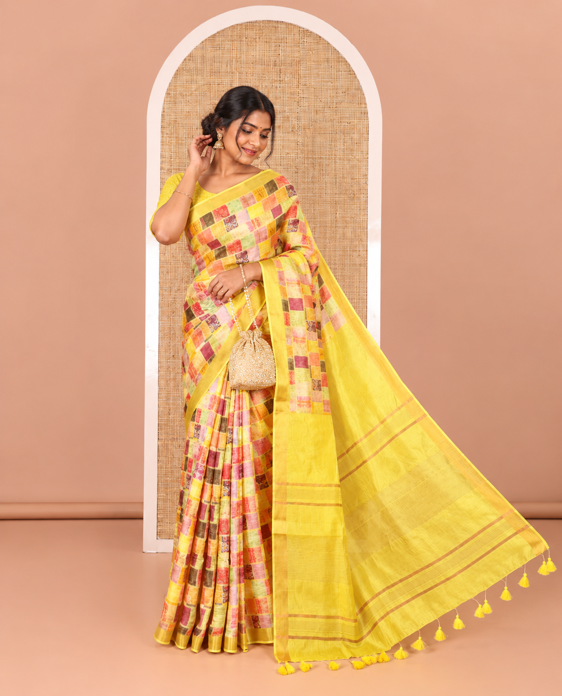 Yellow-base unique motifs enclosed colorful checks printed banana pith saree, zari striped pallu, and a matching blouse