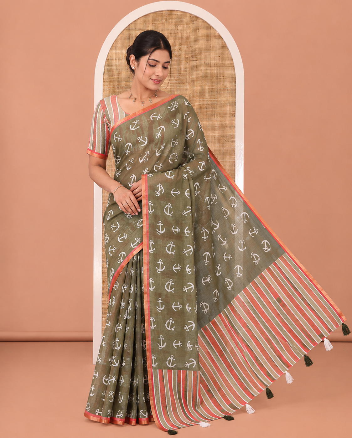 Olive Green Linen Cotton Saree, Steeped with Anchor Motifs Printed on Its Body, a Subtle Contrast Piping Border, Multi-Color Striped Pallu, and Paired with a Contrast Blouse