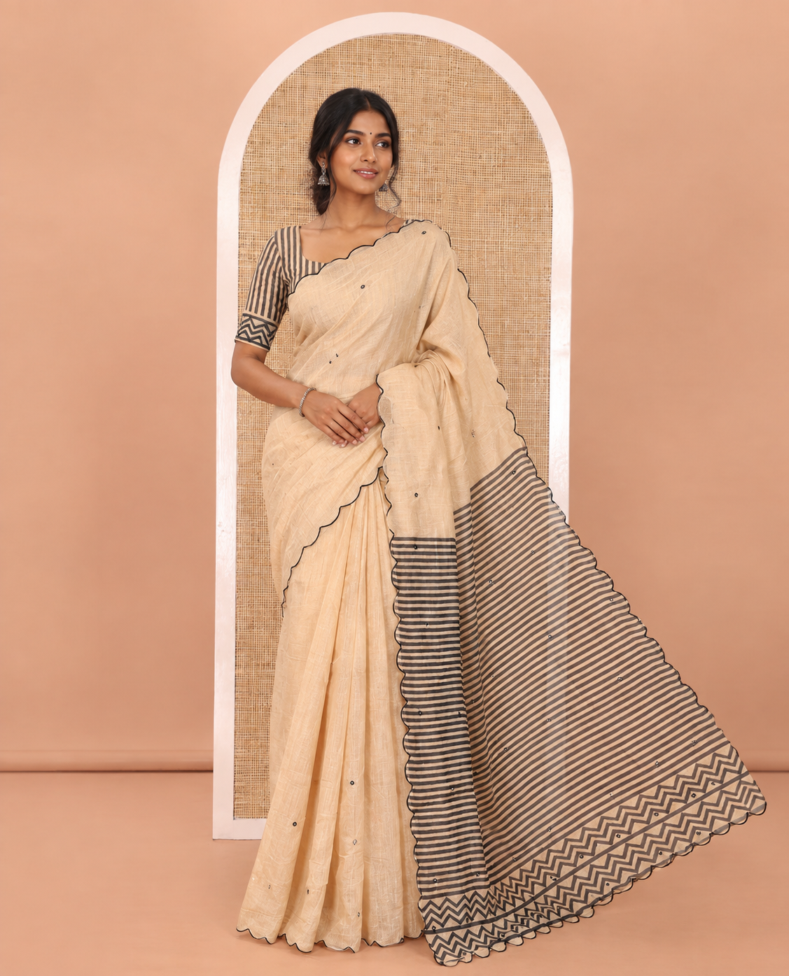 Chikku Linen Cotton Saree, Adorned with Mirror Work All Over Its Body, Subtly Scallop Border, Complemented by Contrast Pallu of Stripes and Mirror Work, and Paired with a Contrast Geometric Printed Blouse