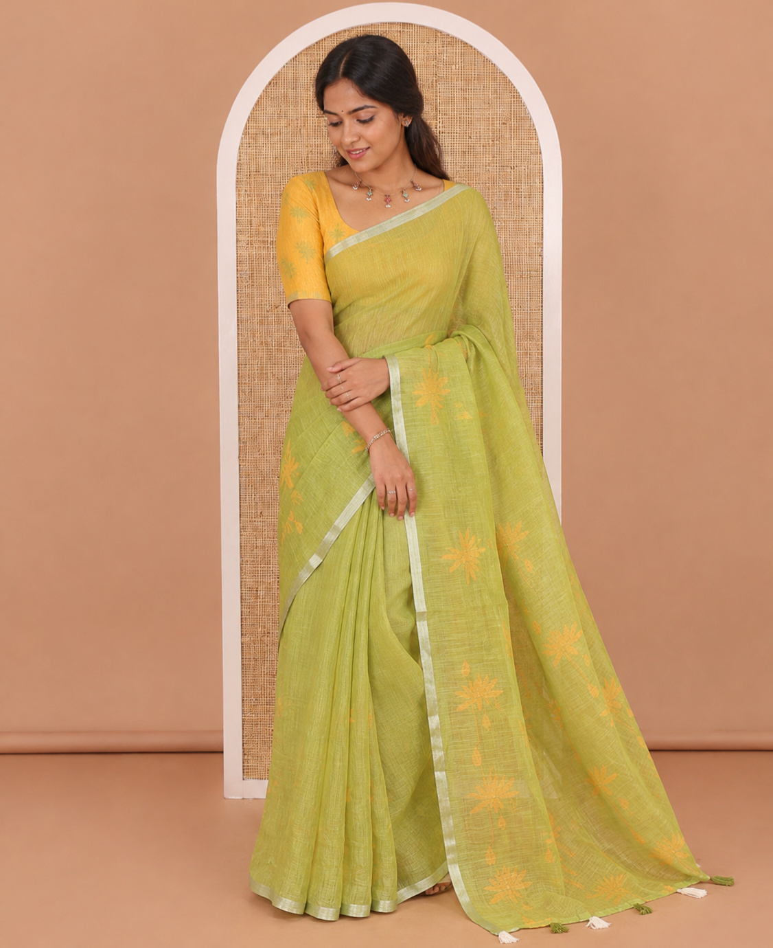 Green Pichwai lotus printed linen cotton saree, piping zari border, colorful tasselled lotus printed pallu, and a contrast lotus printed blouse