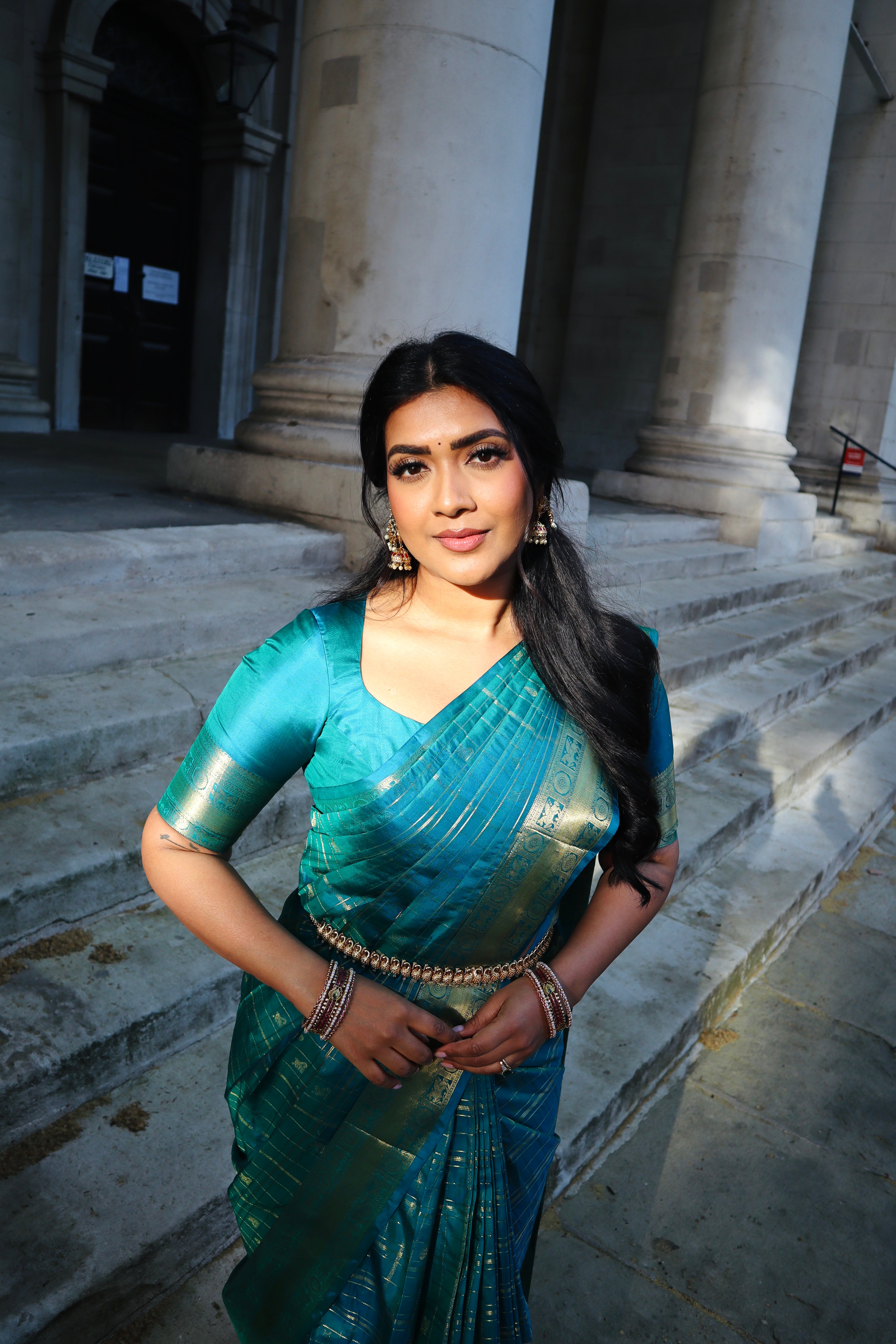 Neelambhari - Peacock Blue Vasundhara Silk Saree Gleamed Up with Zari Buttas Enclosed in Zari Checks, Featuring a Zari Border of Kuthirai and Chakra Designs, Rich Zari Pallu, with a Matching Blouse
