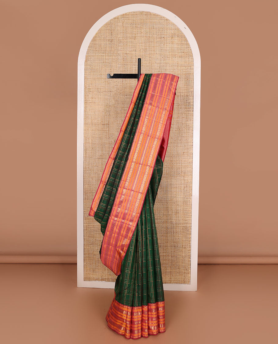 Green checked pure silk saree, contrast border of rekku, plus buttas, muthu, mayil kann, and mayil chakram designs, and zari-rich jaal pallu