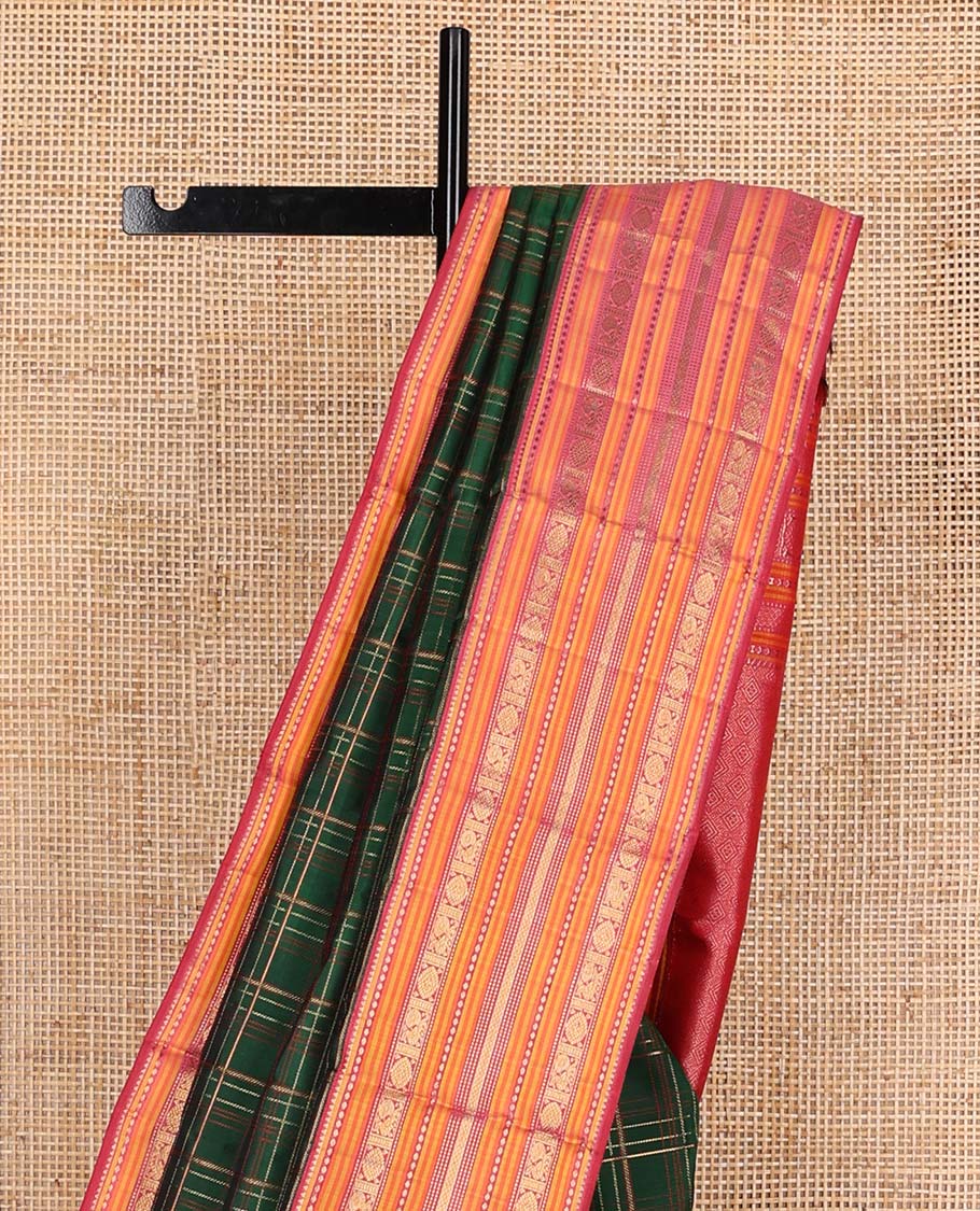 Green checked pure silk saree, contrast border of rekku, plus buttas, muthu, mayil kann, and mayil chakram designs, and zari-rich jaal pallu