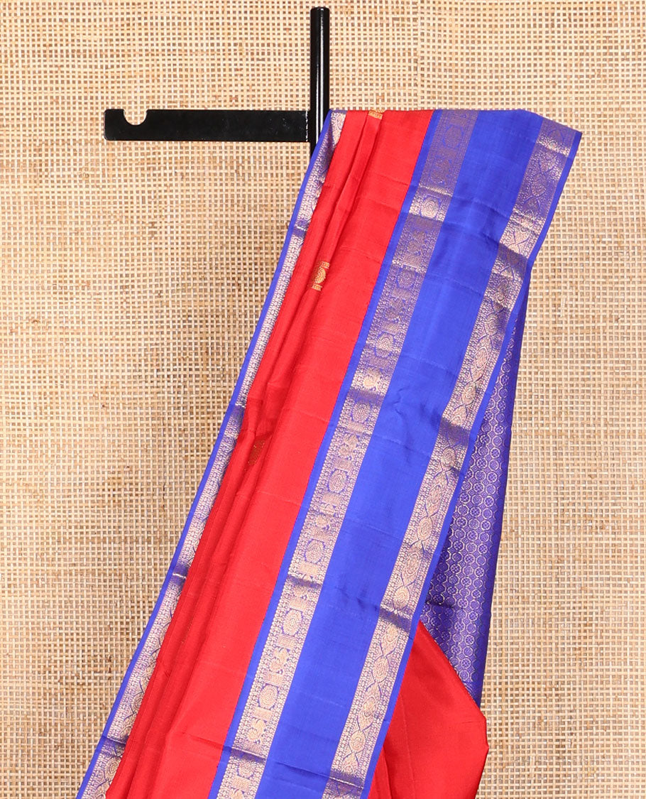 Red zari buttas Kanchipuram silk saree, contrast rettai pettu border of rekku, muthu, diamond, and annam chakram designs, and intricate pallu