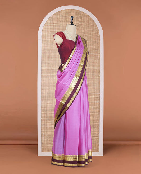 Pink Plain Mysore Silk Saree, Complemented by a Contrast Rettai Pettu Border of Traditional Zari Designs, a Simply Sparkled Pallu of Zari Stripes, and a Contrast Blouse