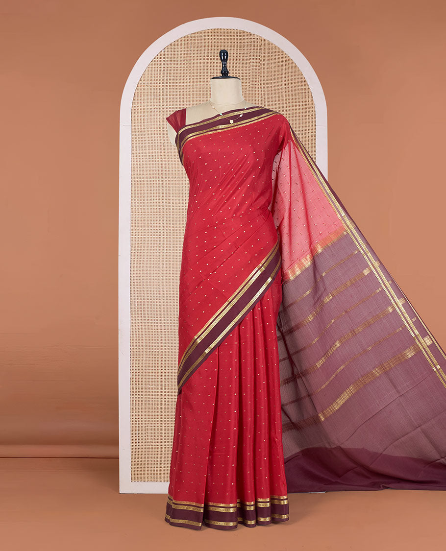 Apple Red Mysore Silk Saree Adorned with Small-Sized Buttas All Over Its Body, Complemented by a Contrast Rettai Pettu Border of Traditional Zari Designs, a Simply Sparkled Pallu of Zari Stripes, and a Contrast Blouse