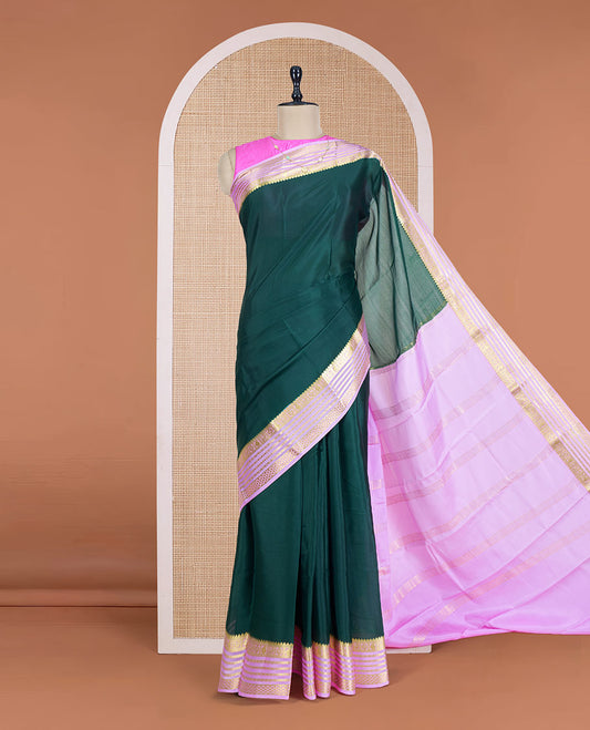 Green Plain Mysore Silk Saree, Complemented by a Contrast Varisai Pettu Border of Traditional Zari Designs, a Subtly Sparkled Pallu of Zari Stripes, and a Contrast Blouse