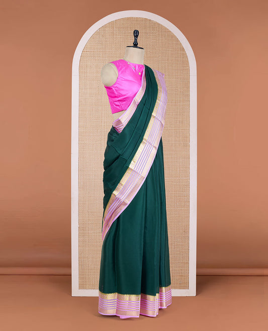 Green Plain Mysore Silk Saree, Complemented by a Contrast Varisai Pettu Border of Traditional Zari Designs, a Subtly Sparkled Pallu of Zari Stripes, and a Contrast Blouse