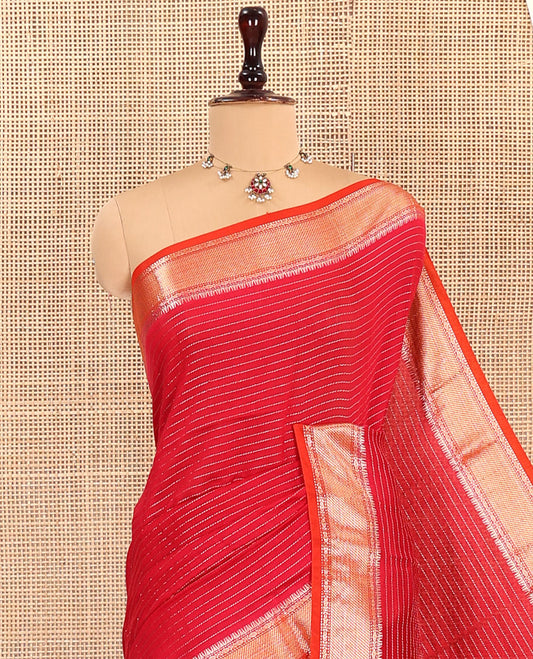 Red Assam Silk Saree, Enthralled with Zari Designs on Its Body, Complemented by a Contrast Traditional Zari Design Border, Pallu Steeped with Gleaming Zari Stripes, and Paired with a Contrast Blouse