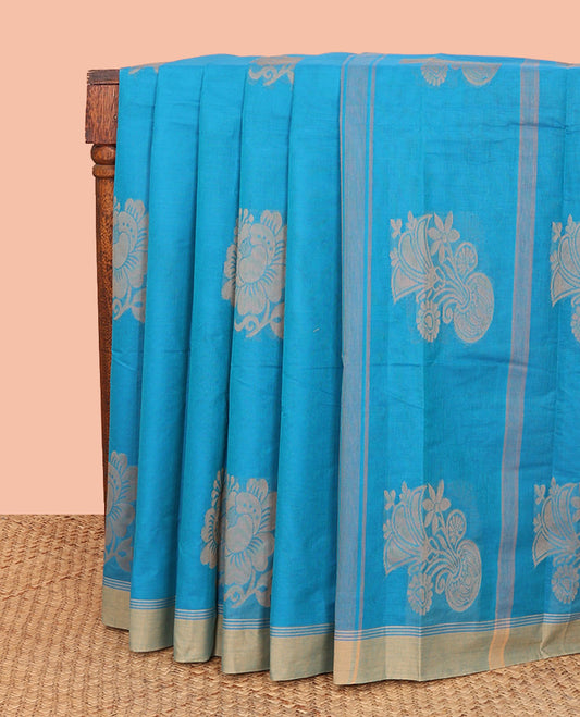 Blue Kanchi Cotton Saree, Subtly Sparkled with Floral Buttas All Over Its Body, Complemented by a Contrast Border, Pallu Steeped with Flower Vase Buttas, and Paired with a Matching Blouse