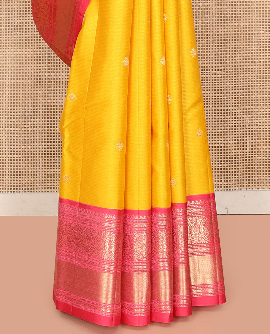Mango Yellow Vasundhara Silk Saree, Subtly Sparkled with Sparse Stripes and Zari Buttas, Complemented by a Contrast Border of Thilakam, Banaras, Muthu, and Round Mayil Designs, Pallu Steeped with Traditional Designs, and Paired with a Contrast Blouse