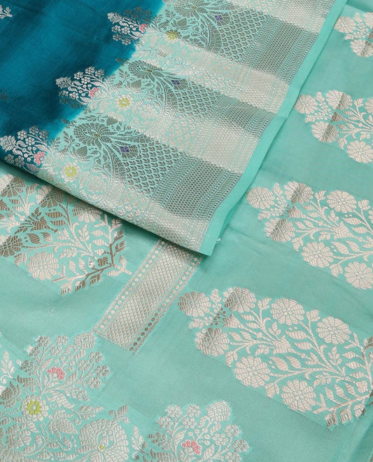 Blue floral buttas raw mango silk saree, contrast traditional zari design meenakari border, and floral bouquet pallu