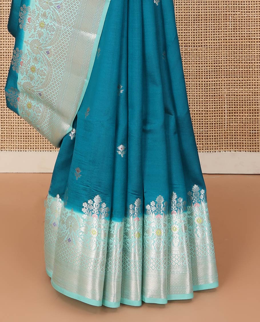 Blue floral buttas raw mango silk saree, contrast traditional zari design meenakari border, and floral bouquet pallu
