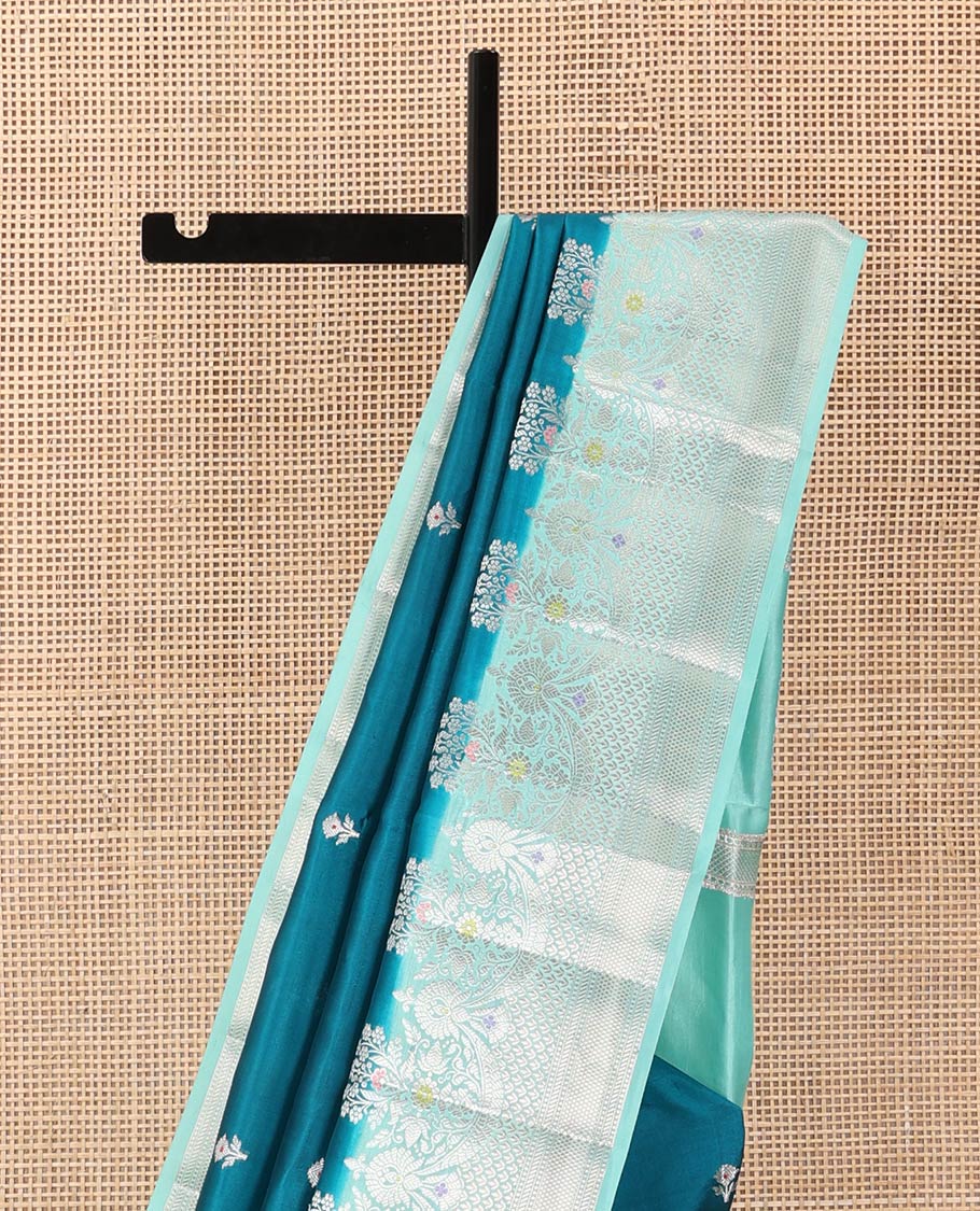 Blue floral buttas raw mango silk saree, contrast traditional zari design meenakari border, and floral bouquet pallu