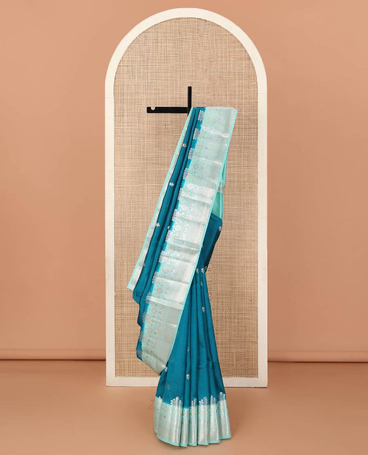 Blue floral buttas raw mango silk saree, contrast traditional zari design meenakari border, and floral bouquet pallu