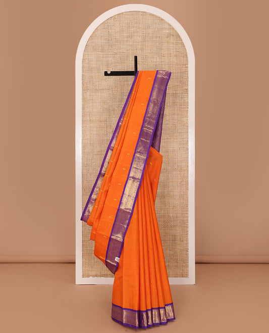 Orange zari buttas Kanchipuram silk saree, contrast korvai border of manga mokku, muthu, diamond, lavangam, and mayil design, and jaal pallu