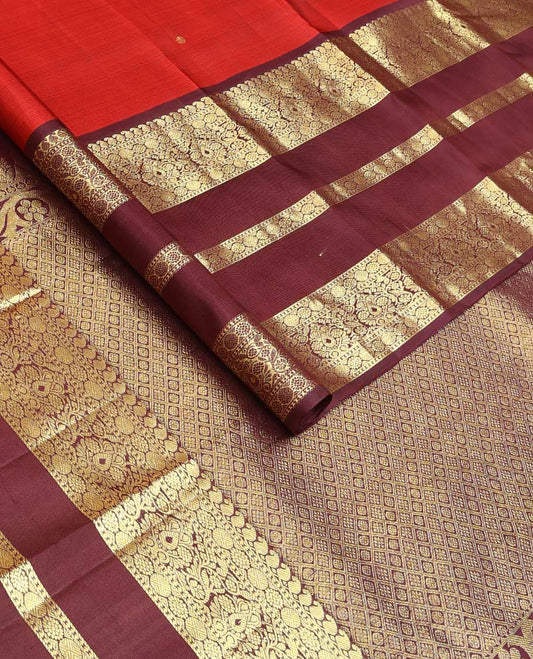 Red zari buttas Kanchipuram silk saree, contrast border of manga mokku, poun, laddu kamalam, and zari designs, and jaal pallu