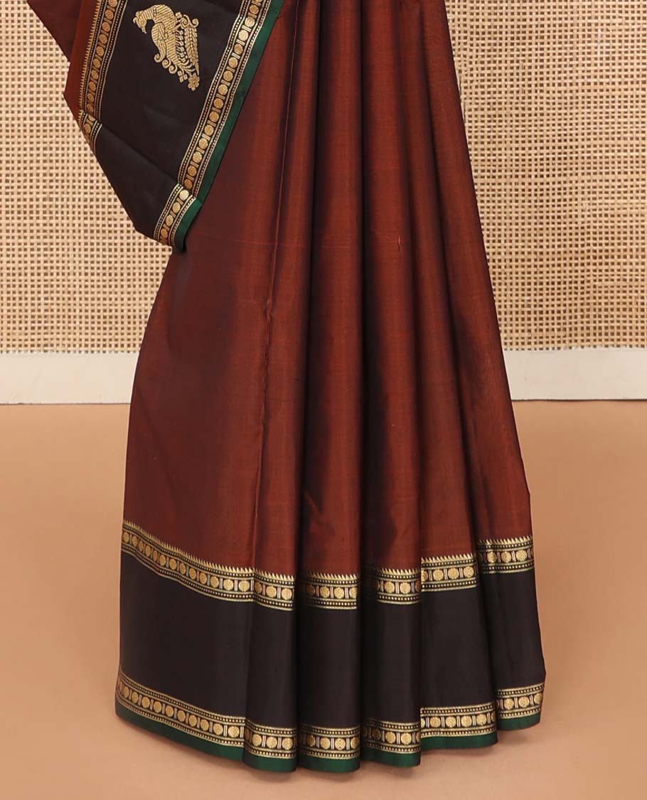 Rust plain Kanchipuram silk saree, contrast border of rekku, muthu, rudraksham and mayil, and zari striped pallu