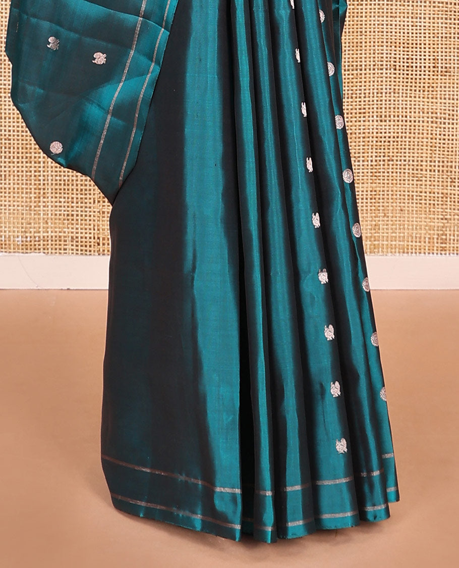 Peacock blue annam chakram buttas soft silk saree, zari piping border, and zari striped pallu