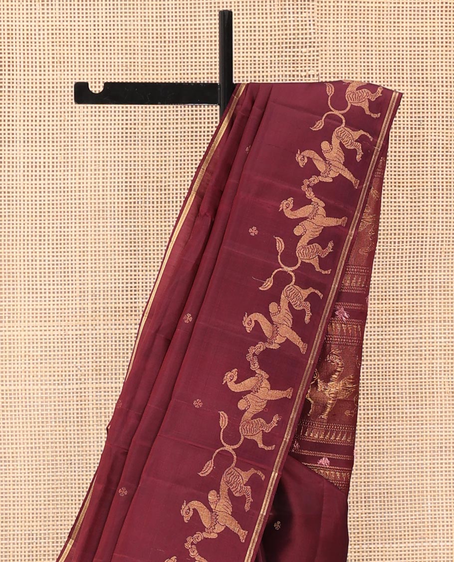 Maroon Mayuri Soft Silk Saree, Adorned with Zari Buttas All Over Its Body, Highlighted by Zari Border of Navagunjara Motifs, Pallu Steeped with Navagunjara Designs, and Paired with a Matching Blouse