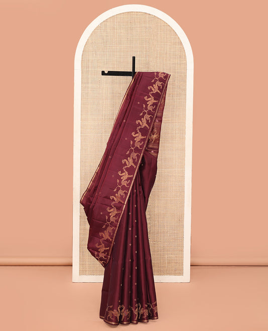Maroon Mayuri Soft Silk Saree, Adorned with Zari Buttas All Over Its Body, Highlighted by Zari Border of Navagunjara Motifs, Pallu Steeped with Navagunjara Designs, and Paired with a Matching Blouse