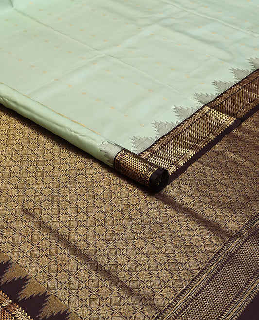 Green nine-yard silksaree with zari buttas,contrast thazampoo reku border of ara bogudi, muthu & ara maadam & jaal pallu