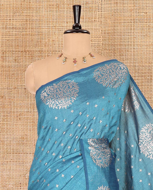 Light blue plus buttas woven Vichitra silk saree, kalpavriksha tree motifs woven on its border, self-pallu, and no blouse