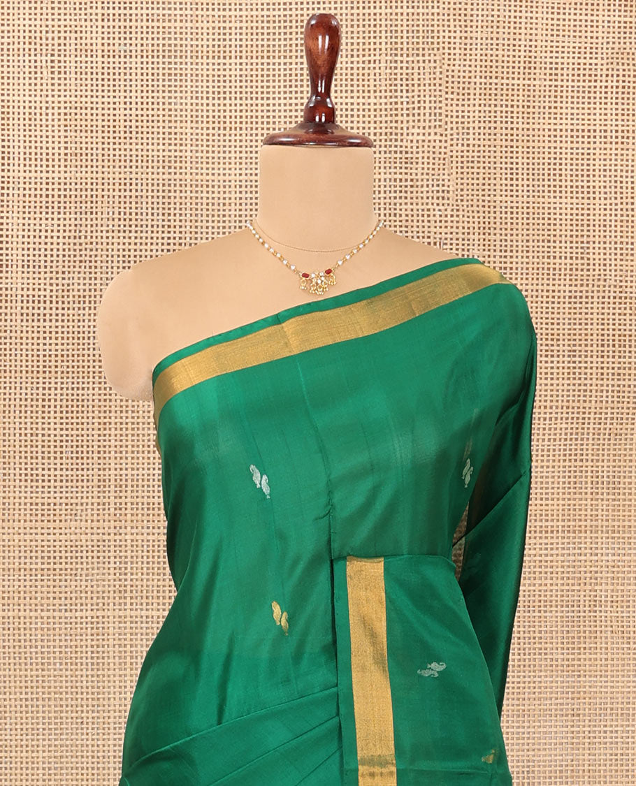 Green Uppada Silk Saree Entralled with Paisley Zari Buttas, Complemented by Bavanji Border, Pallu Depicting Zari Buttas, and Paired with a Matching Blouse