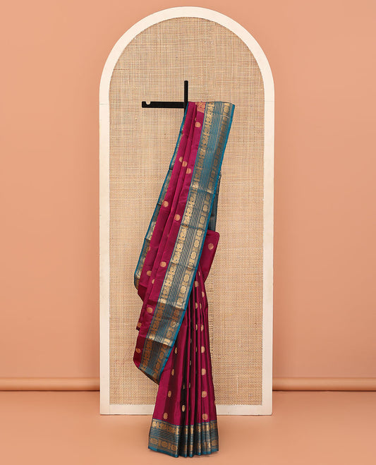 Magenta Vasundhara Lite Silk Mix Saree Featuring Rudraksham Buttas, Complemented by a Contrast Border of Mayil, Cross Neli, Kamalam, Mayil Kann, Muthu, and Chakram Designs, Zari Elevated Pallu, and Paired with a Contrast Zari-Bordered Blouse