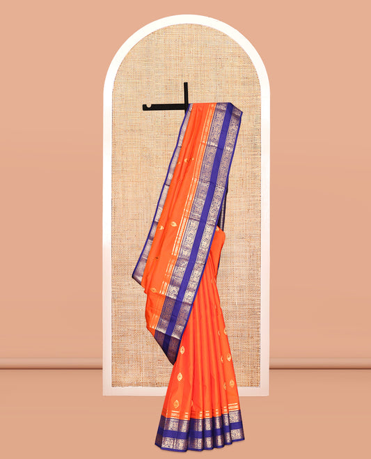 Orange Vasundhara Silk Saree, Adorned with Zari Buttas, Contrast Rettai Pettu Border of Yaanai, and Kuthirai Designs, Grand Pallu, and a Contrast Blouse