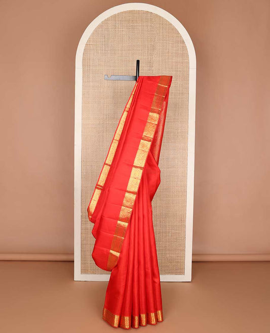Red emnossed design silk saree with self border of thilakam mokku, paun, mayil design & floral pallu