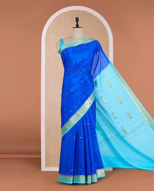 Royal Blue Mysore Silk Saree Adorned with Golden Zari Buttas, Featuring a Contrast Floral-Paisley Design Border, a Pallu Prettified with Zari Designs, and Paired with a Contrast Blouse