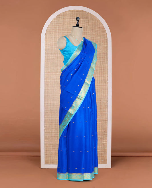 Royal Blue Mysore Silk Saree Adorned with Golden Zari Buttas, Featuring a Contrast Floral-Paisley Design Border, a Pallu Prettified with Zari Designs, and Paired with a Contrast Blouse