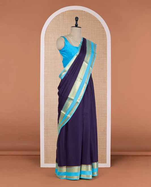 Navy Blue Plain Mysore Silk Saree, Delicately Woven by a Contrast Rettai Pettu Border of Traditional Zari Designs, a Subtly Sparkled Pallu of Zari Stripes, and a Contrast Blouse