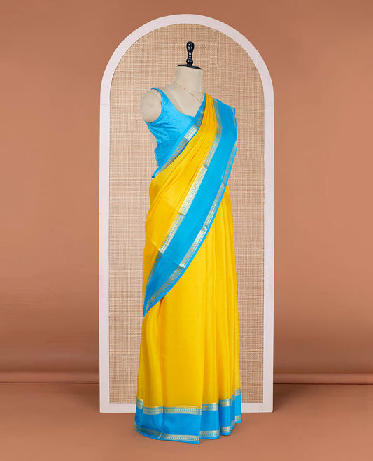 Yellow Plain Mysore Silk Saree, Complemented by a Contrast Rettai Pettu Border of Traditional Zari Designs, a Subtly Sparkled Pallu of Zari Stripes, and a Contrast Blouse