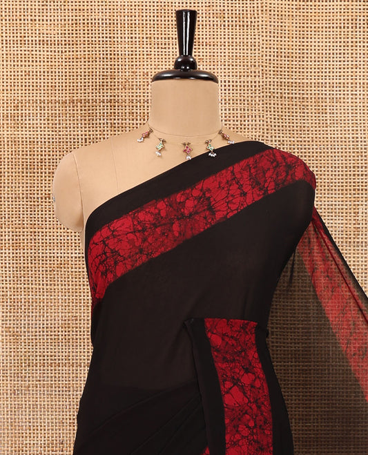 Black and rani pink plain georgette saree, batik printed border, batik printed checked pallu, and a matching blouse