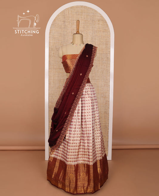 Cream geometric design tissue half saree with contrast zari design border, zari design blouse & floral embroidery dhavani