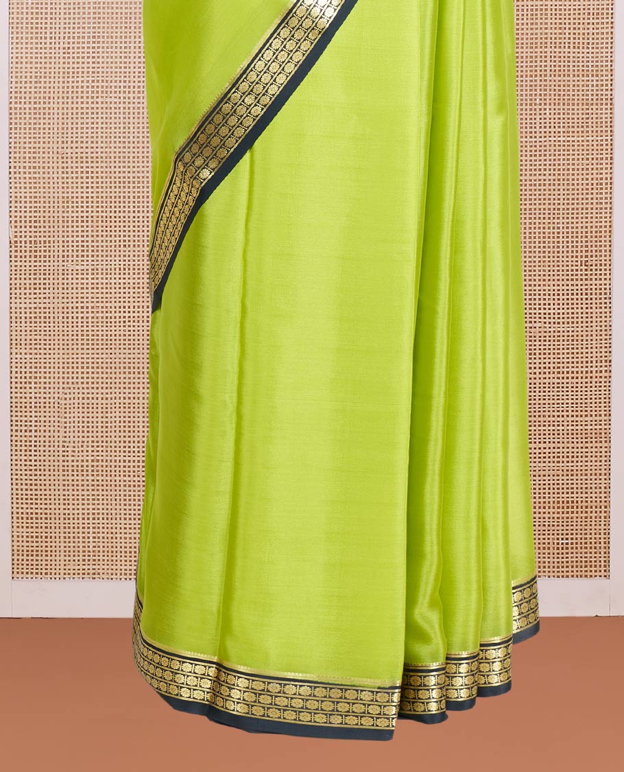 Parrot Green Plain Mysore Silk Saree, Complemented by a Contrast Zari Border of Traditional Designs, a Pallu Gleamed Up with Zari Stripes, and a Contrast Blouse