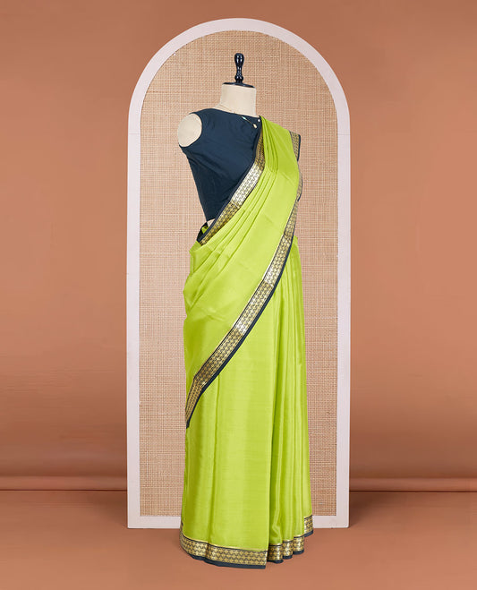 Parrot Green Plain Mysore Silk Saree, Complemented by a Contrast Zari Border of Traditional Designs, a Pallu Gleamed Up with Zari Stripes, and a Contrast Blouse