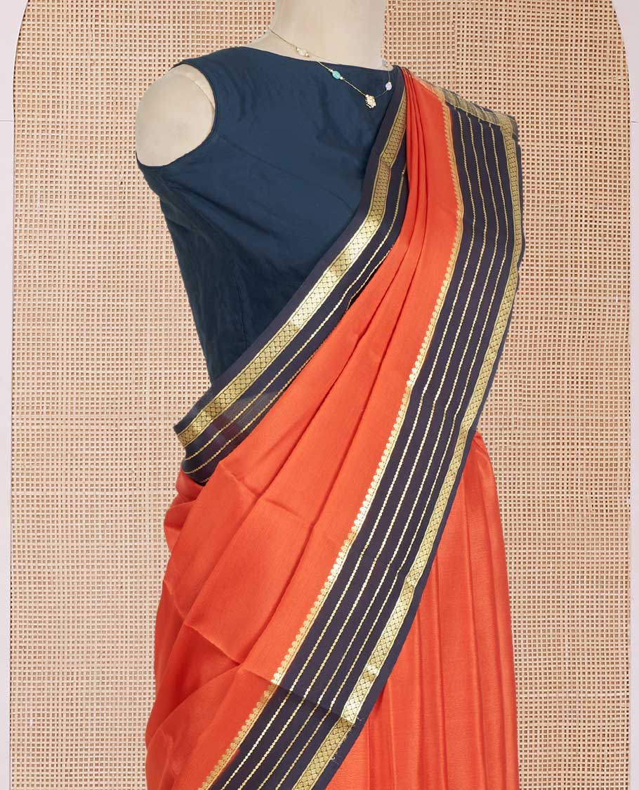 Orange Plain Mysore Silk Saree, Complemented by a Contrast Varisai Pettu Border of Traditional Zari Designs, a Subtly Sparkled Pallu of Zari Stripes, and a Contrast Blouse