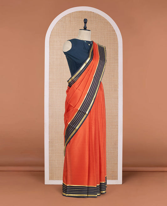 Orange Plain Mysore Silk Saree, Complemented by a Contrast Varisai Pettu Border of Traditional Zari Designs, a Subtly Sparkled Pallu of Zari Stripes, and a Contrast Blouse